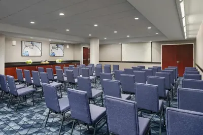 a conference room with rows of chairs and a podium at Courtyard by Marriott New York Manhattan Upper East Side in New York