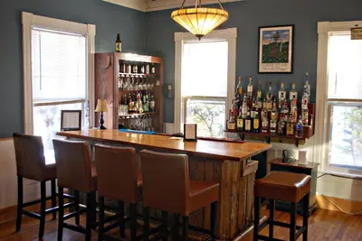 a bar with a wooden counter and some bottles of alcohol at The Wilmington Inn in Wilmington