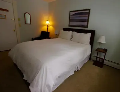 a large white bed in a hotel room at The Wilmington Inn in Wilmington