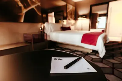 a table with a pen on top of a hotel room at W New York - Times Square in New York