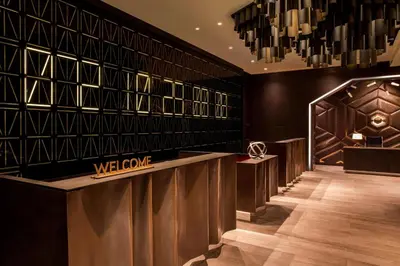 a hotel lobby with a welcome sign and a counter at W New York - Times Square in New York