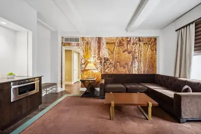 a living room with a couch and a table at Lexington Plaza Hotel in New York