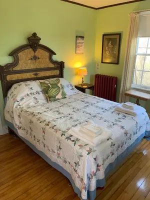 a bedroom with a bed with towels on it at Higganum House B&B in Higganum