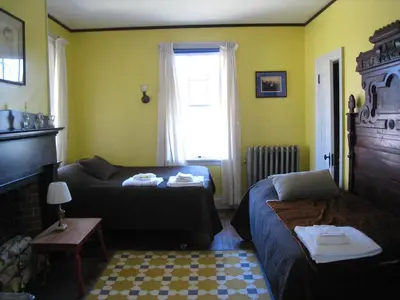 a room with a bed and a couch and a window at Higganum House B&B in Higganum