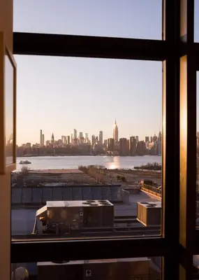 a view of a city skyline from a window at Wythe Hotel in Brooklyn
