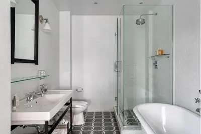 a bathroom with a sink and a tub and a toilet at Wythe Hotel in Brooklyn