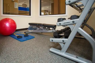 a gym with two treadmills and a red ball at Holiday Inn Express - Springfield Downtown by IHG in Springfield