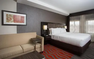 a hotel room with a bed and a couch at Holiday Inn Express - Springfield Downtown by IHG in Springfield