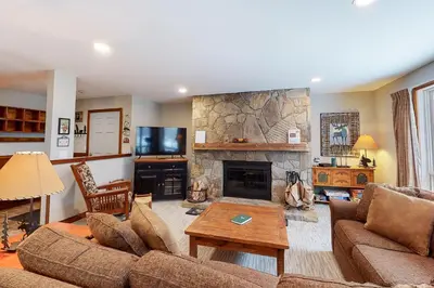 a living room with a couch and a fireplace at The Seasons H23 in Dover