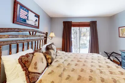 a bedroom with a wooden bed and a window at The Seasons H23 in Dover
