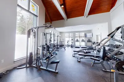 a gym with tread machines and a large window at The Seasons H23 in Dover