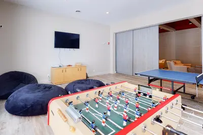 a room with a ping pong table and bean bags at The Seasons H23 in Dover