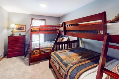 a bedroom with two bunk beds and a dresser at The Seasons H23 in Dover
