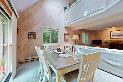 a dining room with a table and chairs and a couch at Valley View: Forest Edge 189 in Dover