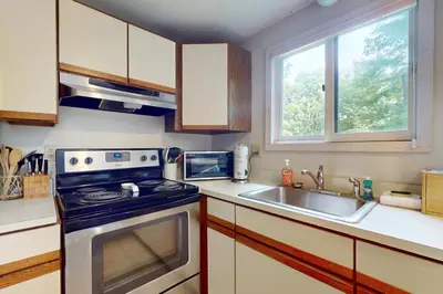 a kitchen with a stove and a sink at Valley View: Forest Edge 189 in Dover
