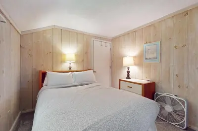 a bedroom with a bed and two lamps and a fan at Valley View: Forest Edge 189 in Dover