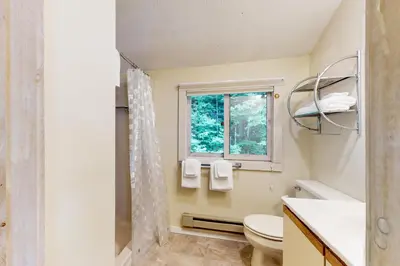 a bathroom with a toilet and a window at Valley View: Forest Edge 189 in Dover