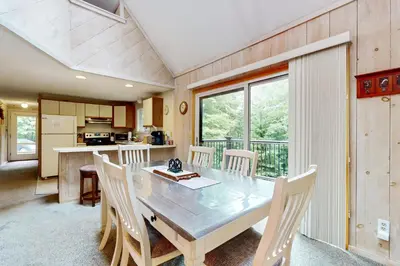 a kitchen and dining room with a table and chairs at Valley View: Forest Edge 189 in Dover