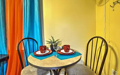 a small table with two cups and two chairs at Two Bedroom Apartment - North East Bronx in Bronx