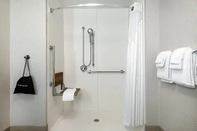 a bathroom with a shower with a glass door at Holiday Inn Express Queensbury-Lake George Area by IHG in Queensbury