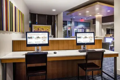 two computer monitors sitting on top of a counter at Holiday Inn Express Queensbury-Lake George Area by IHG in Queensbury