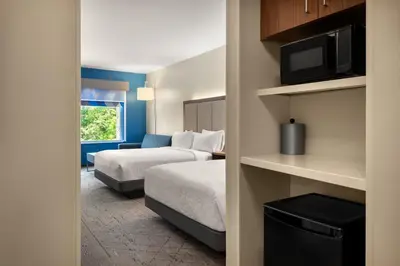 a hotel room with a bed and a tv at Holiday Inn Express Queensbury-Lake George Area by IHG in Queensbury