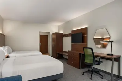 a hotel room with two beds and a desk with a computer at Holiday Inn Express Queensbury-Lake George Area by IHG in Queensbury