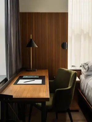 a room with a desk and a chair and a bed at The Moore, New York City, a Member of Design Hotels in New York
