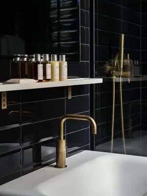 a bathroom with a sink and a shelf with cosmetics at The Moore, New York City, a Member of Design Hotels in New York