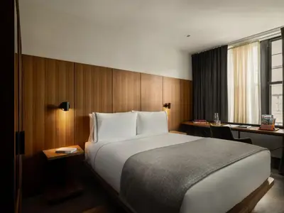 a bedroom with a large bed and a desk at The Moore, New York City, a Member of Design Hotels in New York