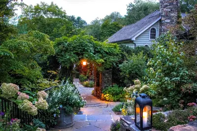 a garden with a lantern in front of a house at Bedford Post Inn in Bedford