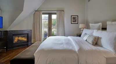 a bedroom with a large bed and a fireplace at Bedford Post Inn in Bedford