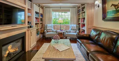 a living room with a couch and a fireplace at Bedford Post Inn in Bedford