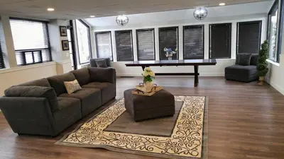 a living room with a couch and a table at Lily's Lodge in West Springfield