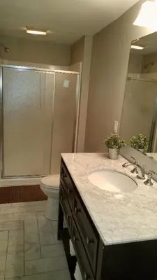 a bathroom with a sink and a shower at Lily's Lodge in West Springfield
