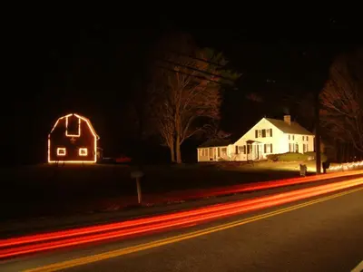 a house with neon lights on a street at night at Truman Gillet House B & B in Granby