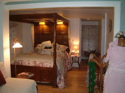 a bedroom with a large bed with a canopy at Truman Gillet House B & B in Granby