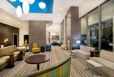 a lobby with couches and chairs and a table at Hilton Garden Inn NYC Financial Center/Manhattan Downtown in New York