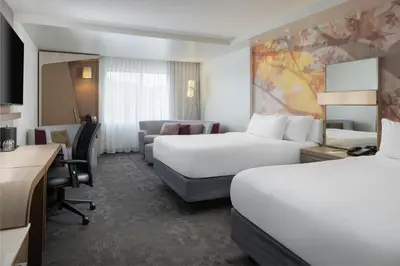 a hotel room with two beds and a desk at Courtyard by Marriott Lenox Berkshires in Lenox