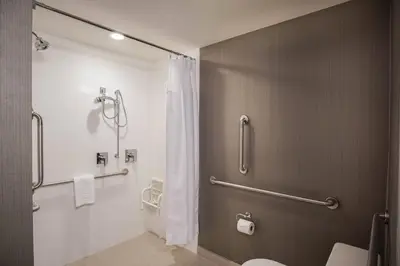 a bathroom with a shower and a toilet at Courtyard by Marriott Lenox Berkshires in Lenox