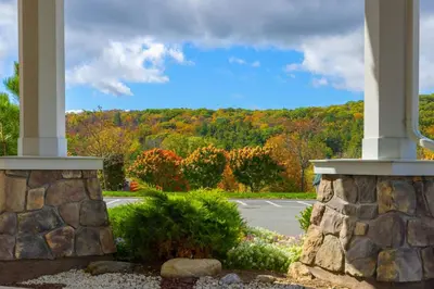 a view from the porch of a house with trees at Courtyard by Marriott Lenox Berkshires in Lenox