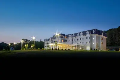 a large building with lights in front of it at Courtyard by Marriott Lenox Berkshires in Lenox