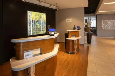 a lobby with a reception desk with a laptop on it at Courtyard by Marriott Lenox Berkshires in Lenox