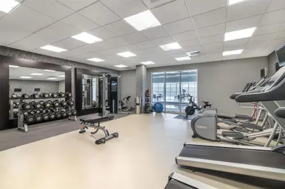 a gym with treadmills and ellipticals in a building at Homewood Suites By Hilton Schenectady in Schenectady