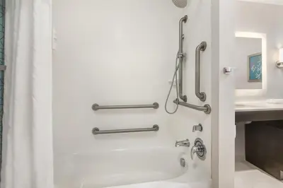 a shower stall in a bathroom with a tub at Homewood Suites By Hilton Schenectady in Schenectady