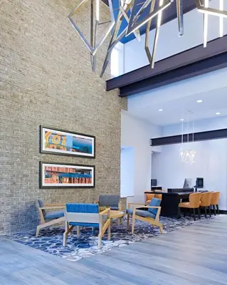 a lobby of a va office with chairs and a table at Hyatt Place Long Island City in Queens