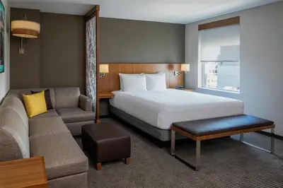 a hotel room with a bed and a couch at Hyatt Place Long Island City in Queens