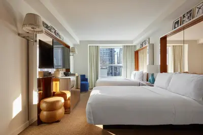 a hotel room with a large bed and a television at Hotel Park Ave NYC in New York