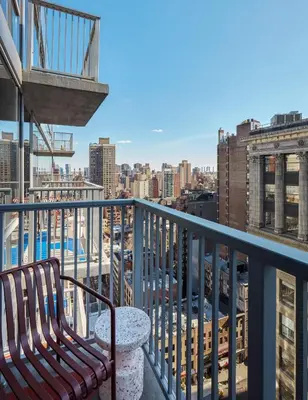 a balcony with a bench and a view of a city at Hotel Park Ave NYC in New York