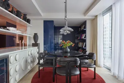 a dining room with a black table and black chairs at Hotel Park Ave NYC in New York